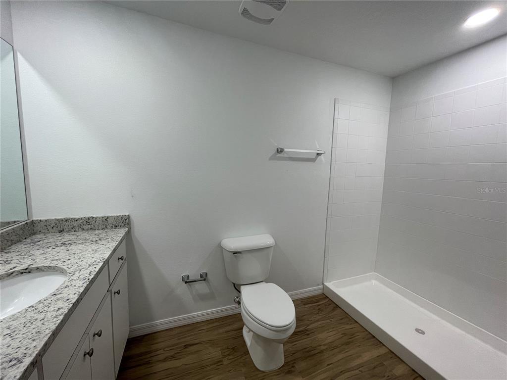 8829 East Marvin Street Floral City, FL 34436 - Photo 9 of 12 a bathroom with a granite countertop toilet and a sink