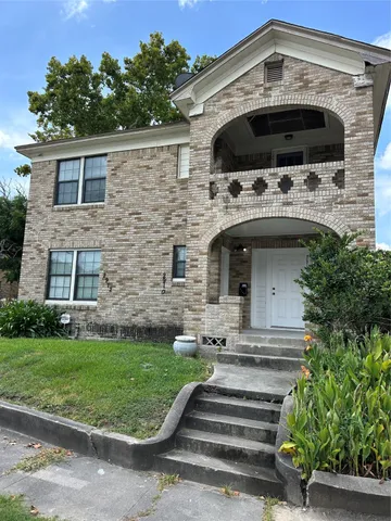 a front view of a house with a garden