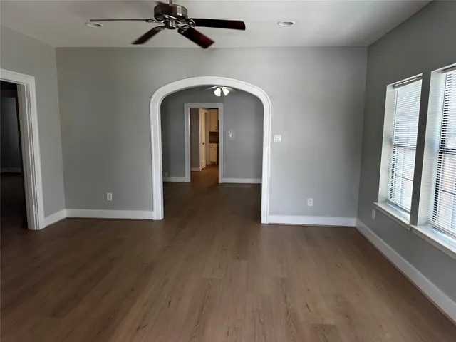 a view of a livingroom with wooden floor and a window