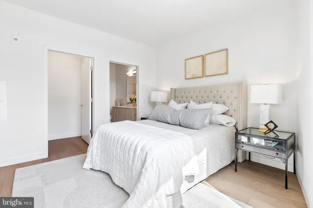 a bedroom with a bed and a lamp