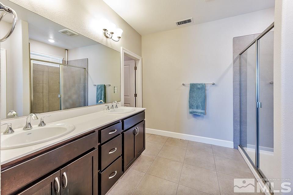 1920 Dark Horse Road, Unit A103 Reno, NV 89521 - Photo 11 of 15 a spacious bathroom with a granite countertop sink a mirror and a