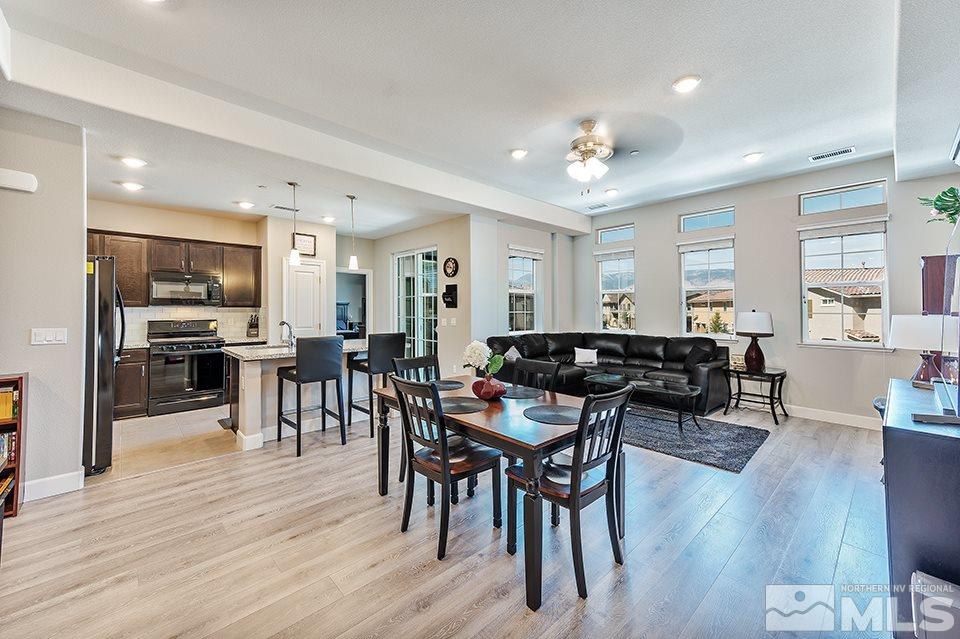 1920 Dark Horse Road, Unit A103 Reno, NV 89521 - Photo 4 of 15 a living room with furniture a wooden floor and a view of kitchen