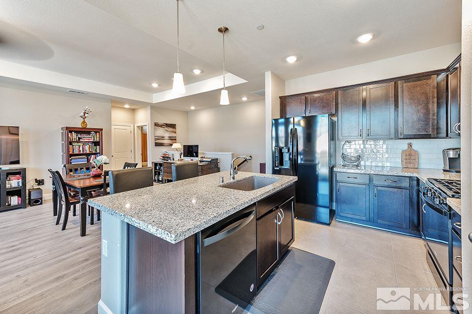 1920 Dark Horse Road, Unit A103 Reno, NV 89521 - Photo 8 of 15 a kitchen with center island table and chairs
