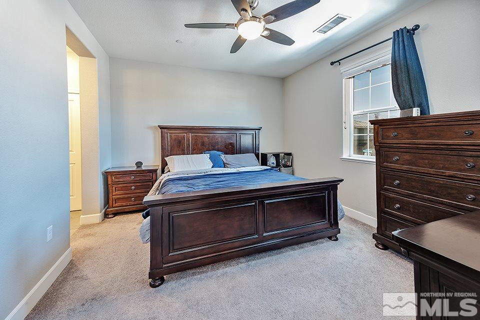 1920 Dark Horse Road, Unit A103 Reno, NV 89521 - Photo 10 of 15 a bed room with a bed and a television