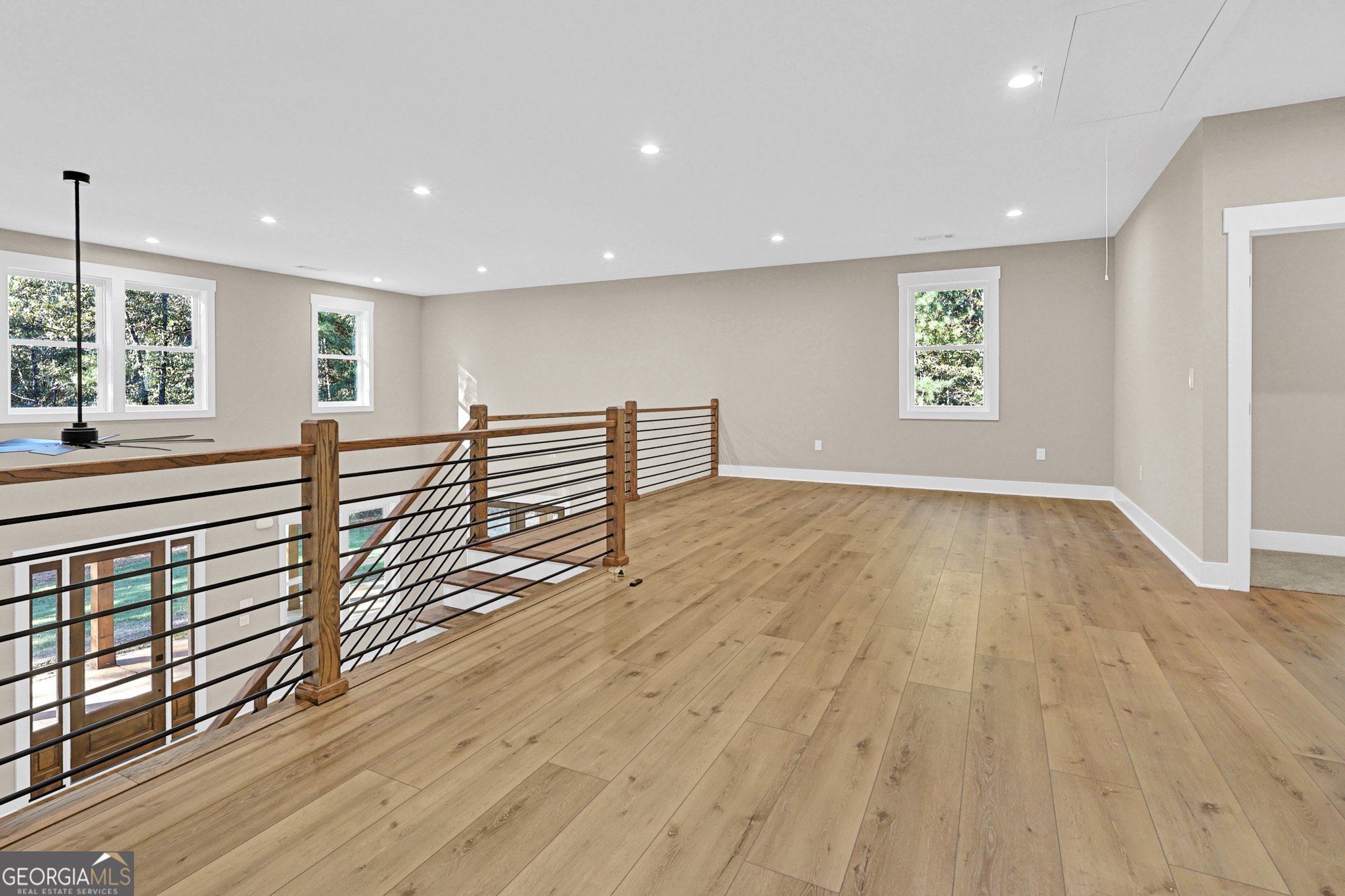 507 North Ridge Road Barnesville, GA 30204 - Photo 17 of 22 an empty room with wooden floor and windows