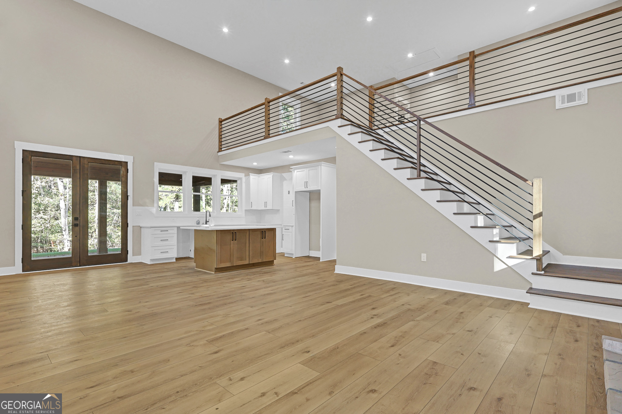 507 North Ridge Road Barnesville, GA 30204 - Photo 6 of 22 a view of an empty room with wooden floor and stairs