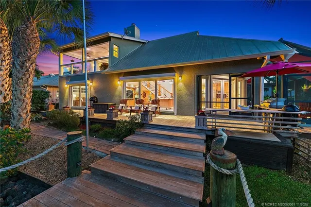 a view of a room with a large window and dining table and chairs