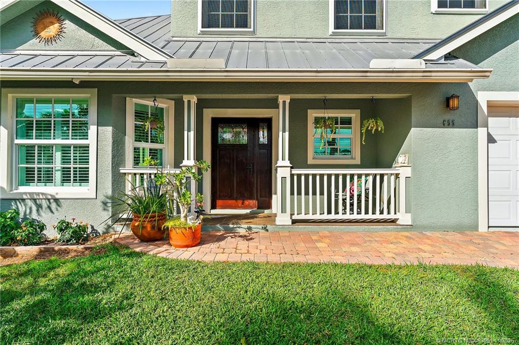 655 Southwest Salerno Road Stuart, FL 34997 - Photo 19 of 84 a front view of a house with a yard