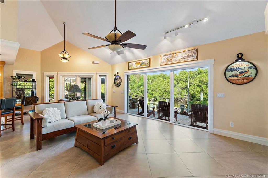 655 Southwest Salerno Road Stuart, FL 34997 - Photo 32 of 84 a living room with furniture and a large window