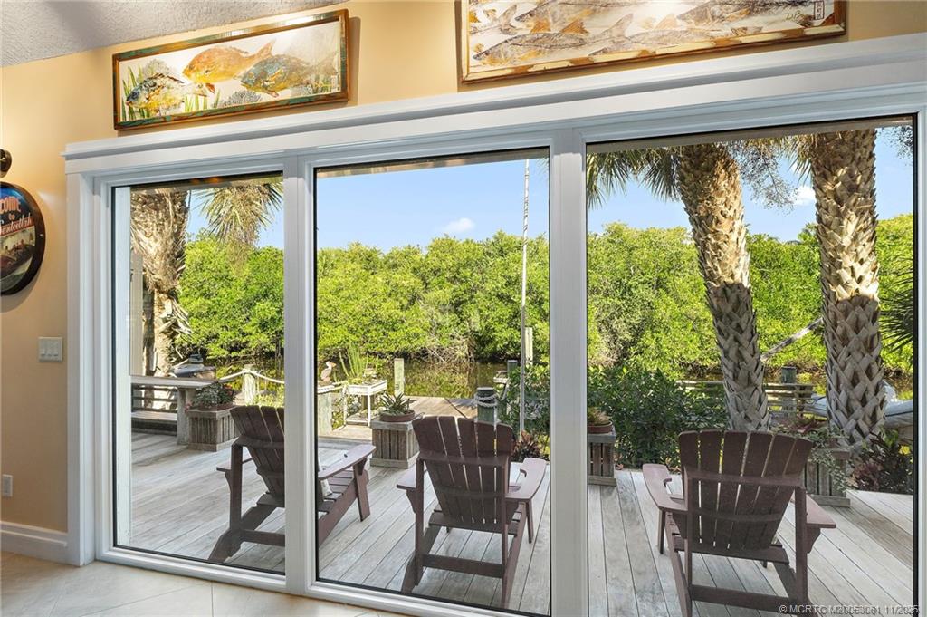 655 Southwest Salerno Road Stuart, FL 34997 - Photo 34 of 84 a view of a room with a large window and dining table and chairs