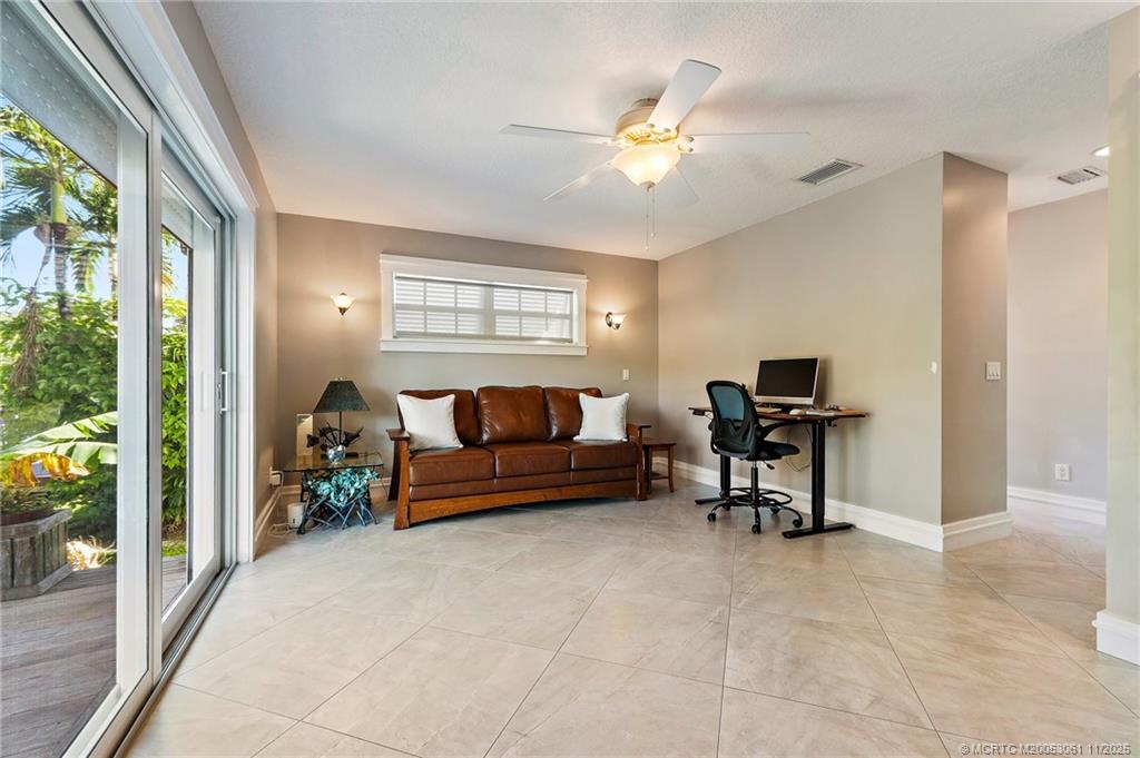 655 Southwest Salerno Road Stuart, FL 34997 - Photo 35 of 84 a living room with furniture and a potted plant