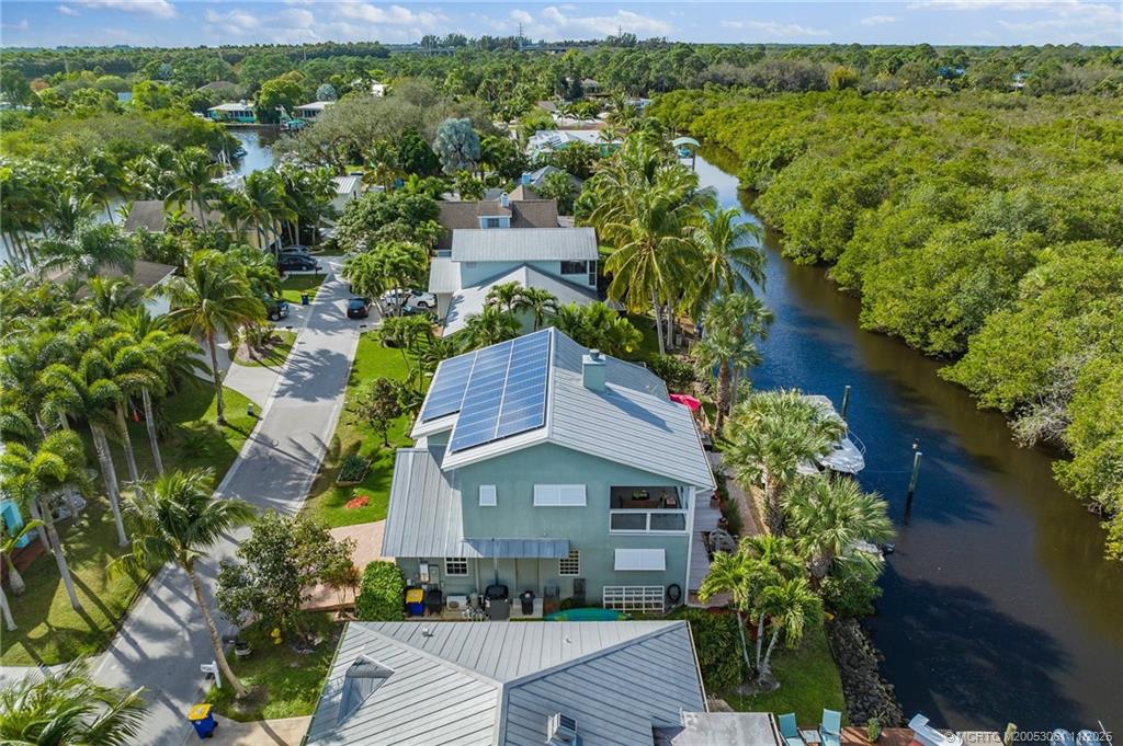 655 Southwest Salerno Road Stuart, FL 34997 - Photo 5 of 84 a aerial view of a house with a yard and large trees