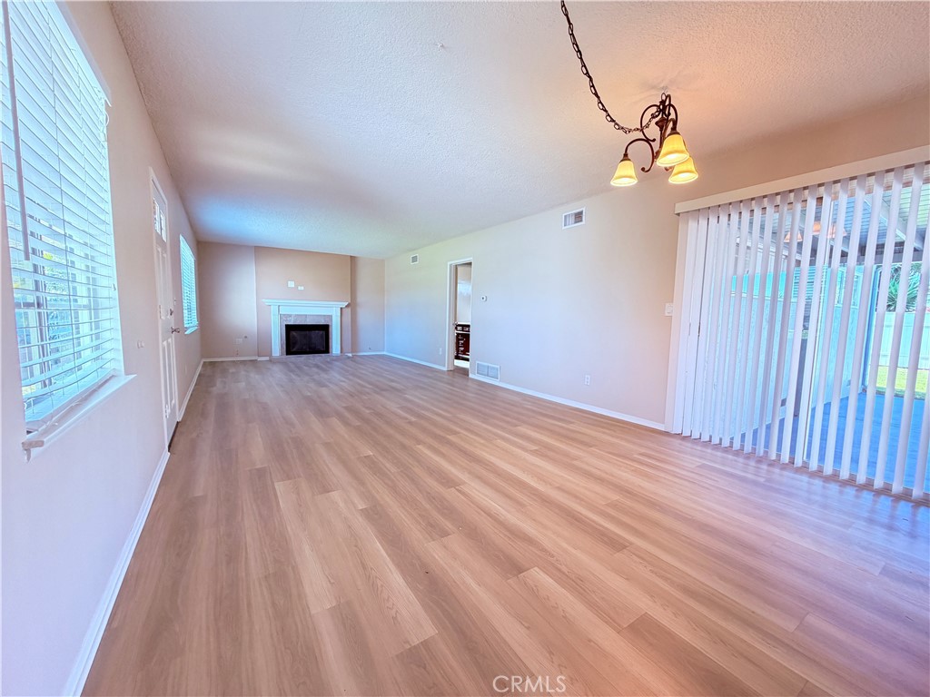 14820 Ragan Drive La Mirada, CA 90638 - Photo 3 of 27 Expansive Living Room and Dining Area with Fireplace (includes gas logs).