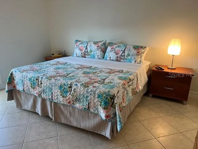 a bedroom with a bed and a lamp