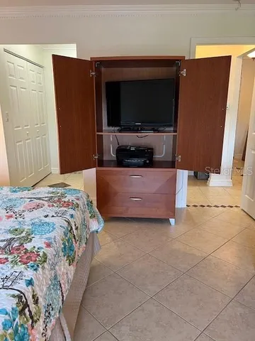 a bedroom with a bed and a television in it