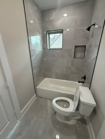 a bathroom with a toilet a sink and a bathtub