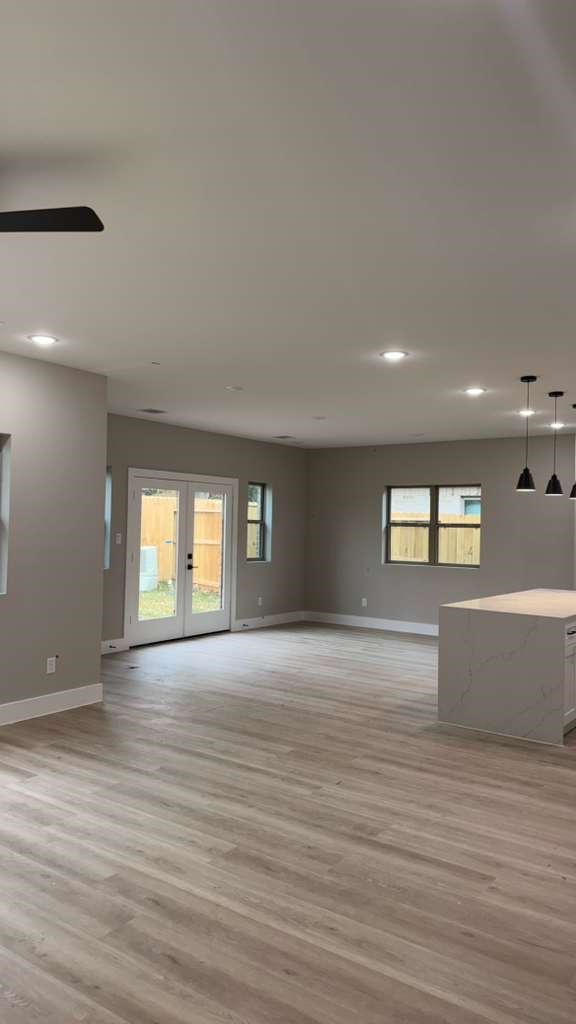 20007 Venetto Street Spring, TX 77388 - Photo 3 of 20 an empty room with wooden floor and windows