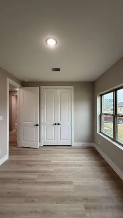 wooden floor in an empty room with a window
