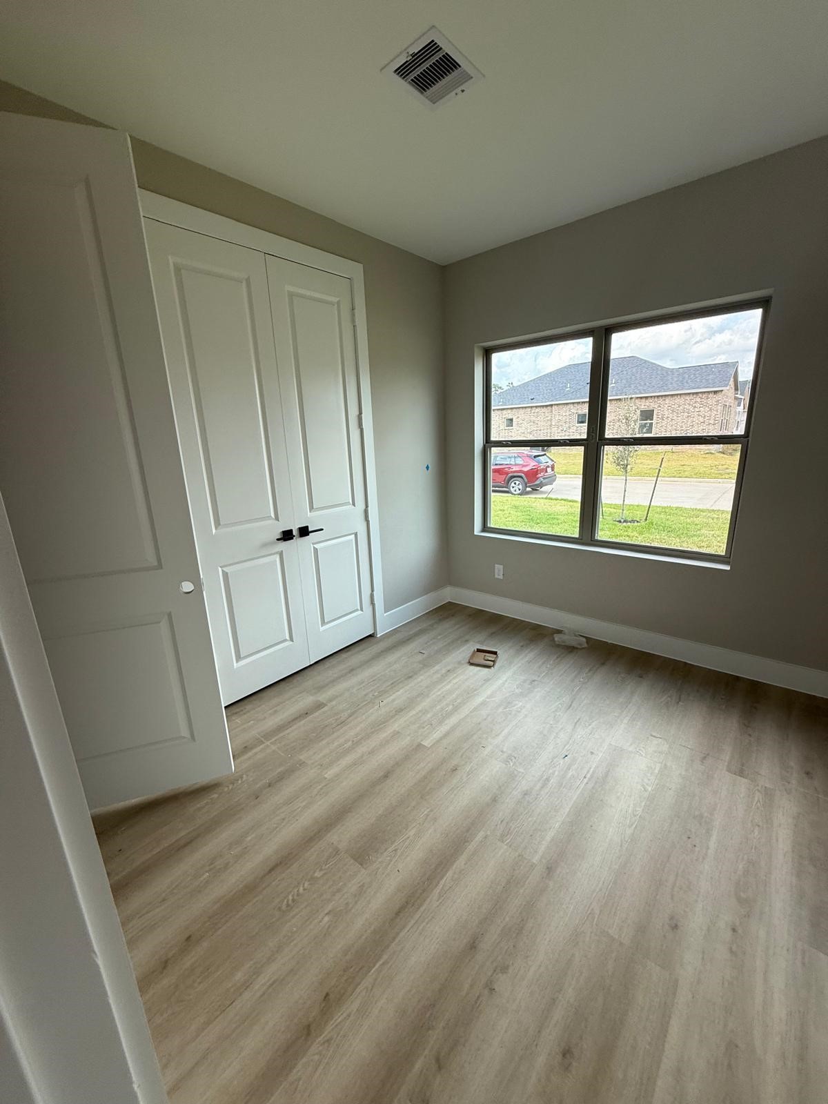 20007 Venetto Street Spring, TX 77388 - Photo 10 of 20 an empty room with wooden floor and windows