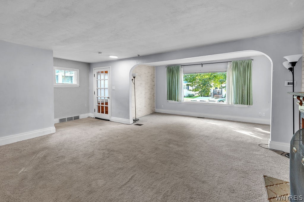 164 Shenandoah Road Buffalo, NY 14220 - Photo 17 of 50 Living room into family room with large window and