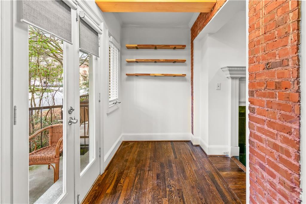 2840 Peachtree Road Northwest, Unit 312 Atlanta, GA 30305 - Photo 12 of 42 a view of a hallway with wooden floor and a cabinet