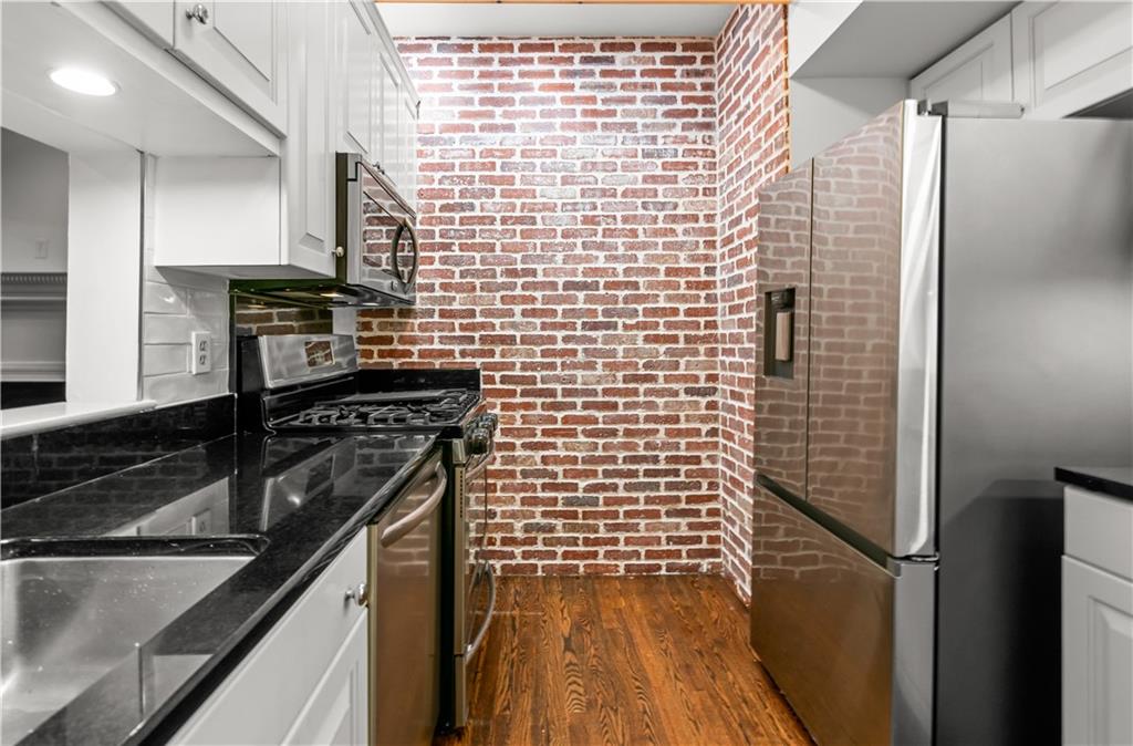 2840 Peachtree Road Northwest, Unit 312 Atlanta, GA 30305 - Photo 17 of 42 a kitchen with a refrigerator and a stove