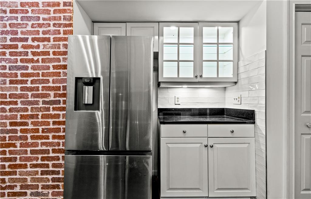 2840 Peachtree Road Northwest, Unit 312 Atlanta, GA 30305 - Photo 19 of 42 a kitchen with cabinets and a stainless steel appliances