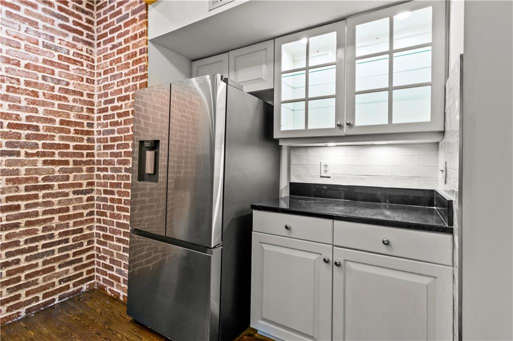 2840 Peachtree Road Northwest, Unit 312 Atlanta, GA 30305 - Photo 20 of 42 a kitchen with stainless steel appliances granite countertop a refrigerator and a sink