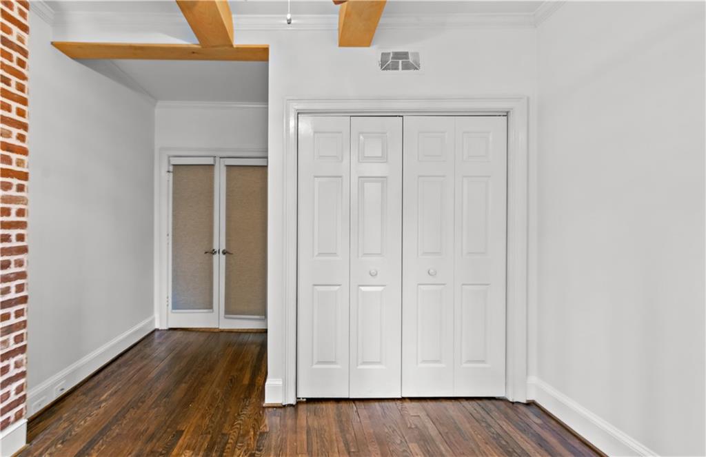 2840 Peachtree Road Northwest, Unit 312 Atlanta, GA 30305 - Photo 23 of 42 a view of an empty room with wooden floor