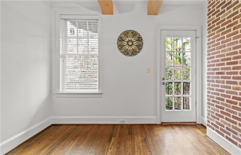 2840 Peachtree Road Northwest, Unit 312 Atlanta, GA 30305 - Photo 25 of 42 a view of an empty room with wooden floor and a window