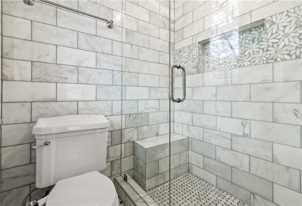 2840 Peachtree Road Northwest, Unit 312 Atlanta, GA 30305 - Photo 28 of 42 a bathroom with a toilet and a shower