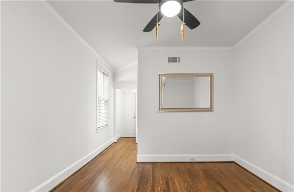 2840 Peachtree Road Northwest, Unit 312 Atlanta, GA 30305 - Photo 31 of 42 an empty room with wooden floor fan and windows