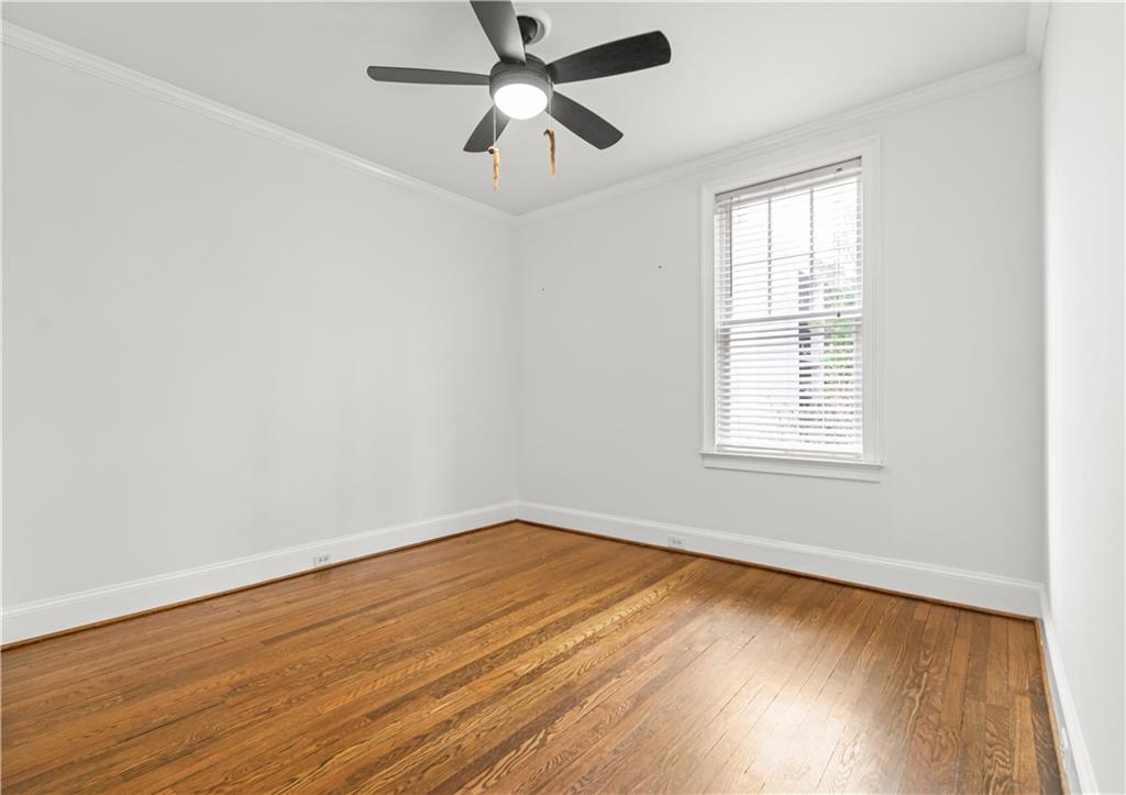 2840 Peachtree Road Northwest, Unit 312 Atlanta, GA 30305 - Photo 33 of 42 an empty room with wooden floor fan and windows