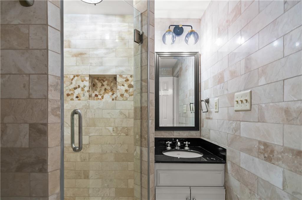 2840 Peachtree Road Northwest, Unit 312 Atlanta, GA 30305 - Photo 36 of 42 a bathroom with a shower