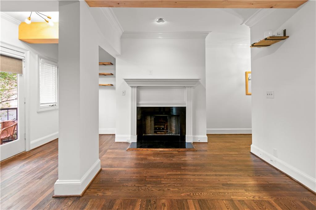 2840 Peachtree Road Northwest, Unit 312 Atlanta, GA 30305 - Photo 6 of 42 a view of an empty room with wooden floor and a window