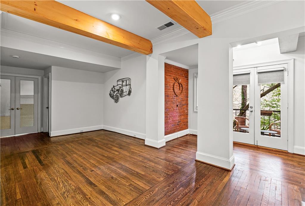 2840 Peachtree Road Northwest, Unit 312 Atlanta, GA 30305 - Photo 10 of 42 a view of an empty room with window and wooden floor