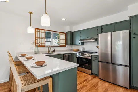 a kitchen with refrigerator cabinets and wooden floor