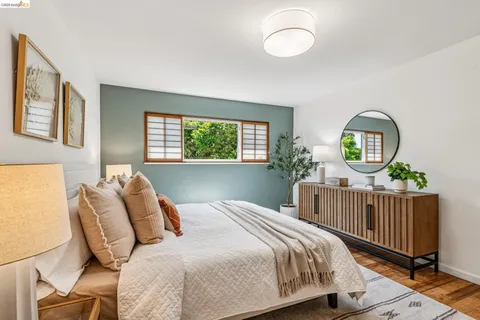 a bedroom with a bed a window and dresser