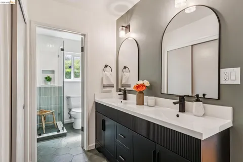 a bathroom with a double vanity sink and a mirror