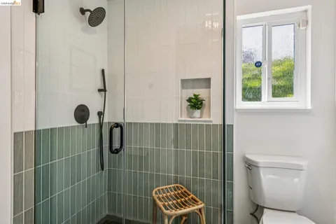 a bathroom with a toilet and a shower