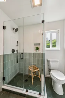 a bathroom with a toilet and a shower