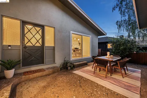 a view of a patio with a table and chairs