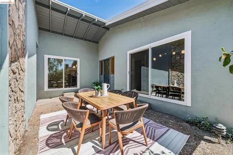a view of a patio with table and chairs