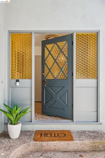 a view of a door with a potted plant and a window