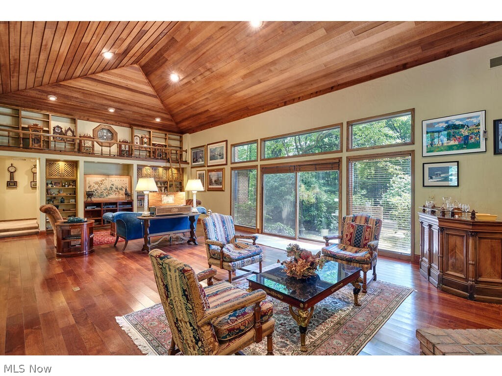 Two Story Great Room features beautiful wood ceiling and doors to rear grounds for stunning views upon entering this architecturally-unique home.