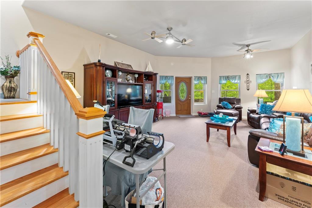 320 Holly Lane Walhalla, SC 29691 - Photo 38 of 41 This inviting living space features warm natural light and convenient access to the staircase.