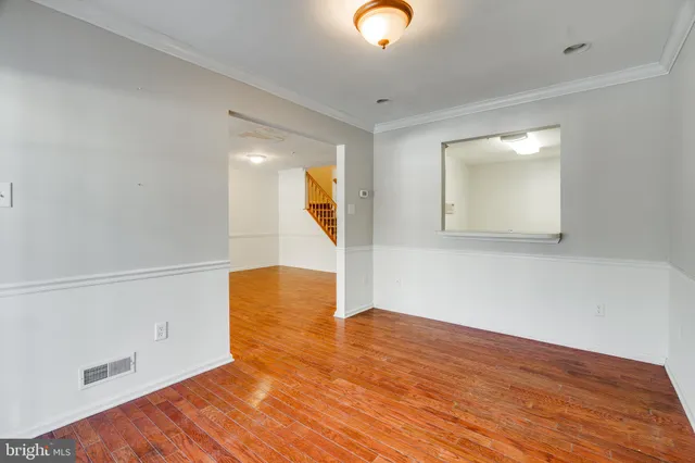 a view of a room with wooden floor