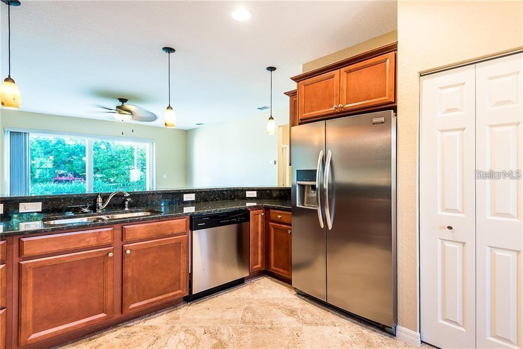 3948 San Rocco Drive, Unit 112 Punta Gorda, FL 33950 - Photo 8 of 18 a kitchen with stainless steel appliances granite countertop a sink a stove and refrigerator