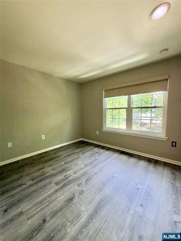 35 Harrier Court, Unit 35 Wayne, NJ 07470 - Photo 9 of 16 an empty room with wooden floor and windows