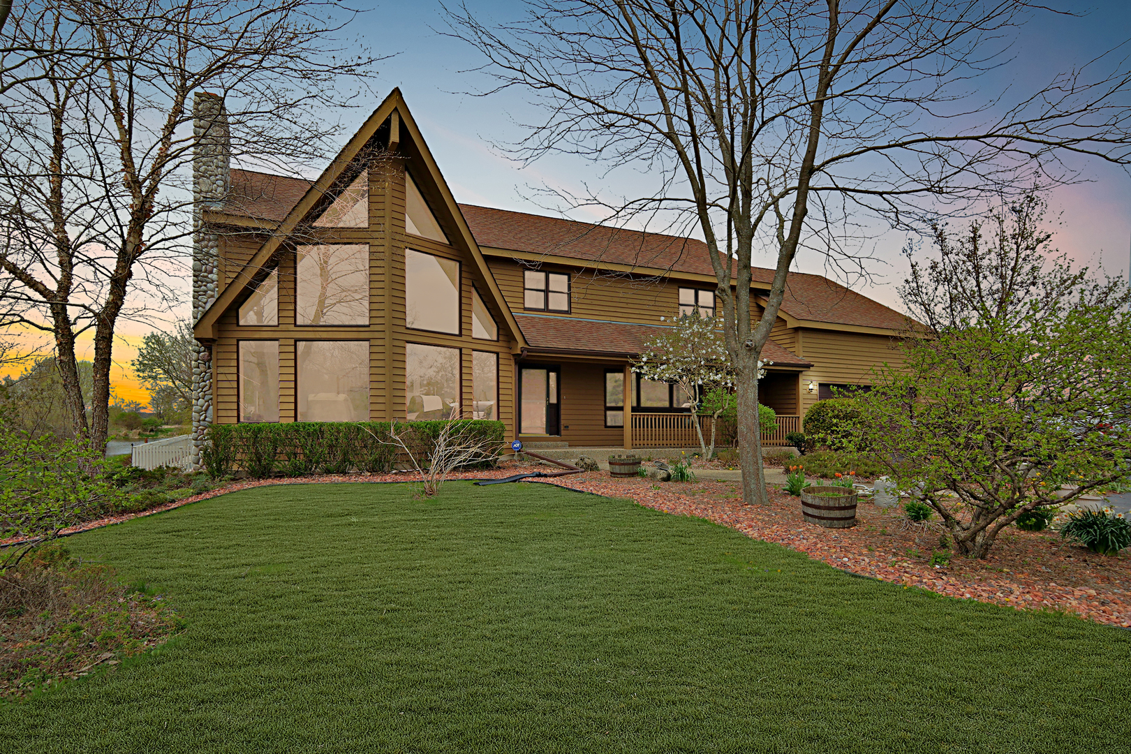 a front view of a house with patio and garden